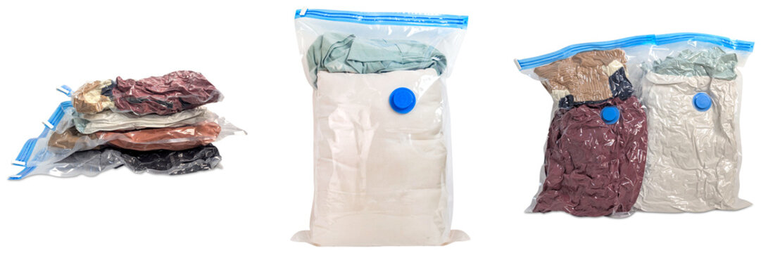 Stack of vacuum sealed bags filled with clothes and bedding, isolated on white background