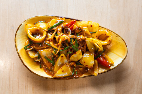 Delicious Thai stir fry squid with onion, and chili pepper, common dish in Thai menu