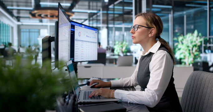 Young Woman Managing IT Support Tickets On Laptop