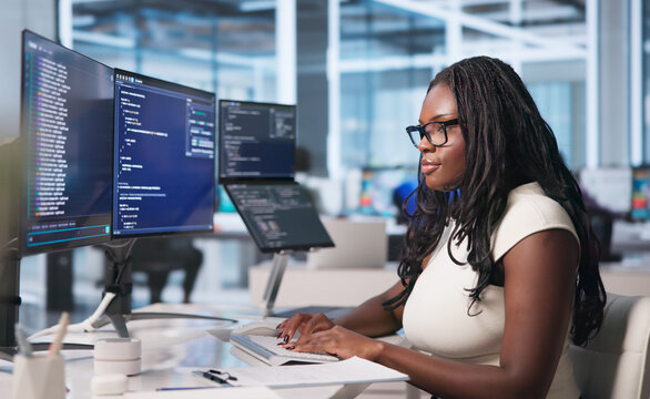 Young Woman Writes Code On Laptop
