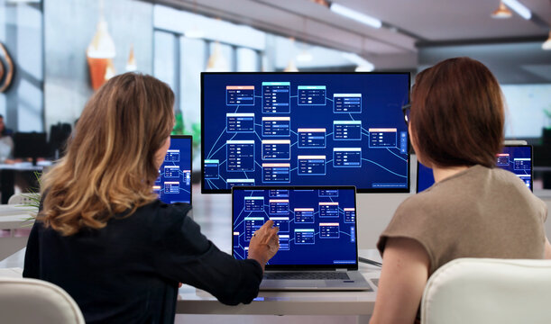 Young Woman Shows Team How To Build Automated Workflow