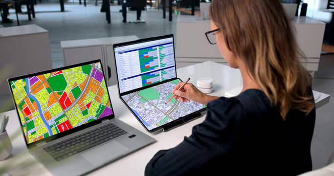 Mature Urban Planner Uses Foldable Laptop