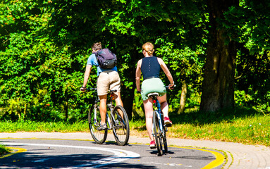 Fototapeta premium Cyclists ride on the bike path in the city Park 
