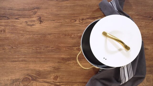Person placing white lid onto ceramic pot