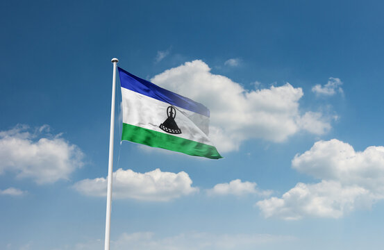 Lesotho flag waving in beautiful sky.