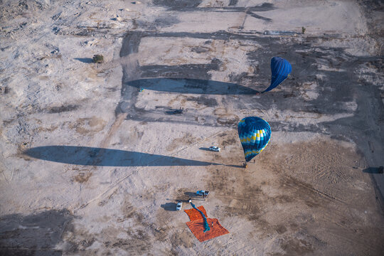 Aerial view of hot air balloons preparing in desert