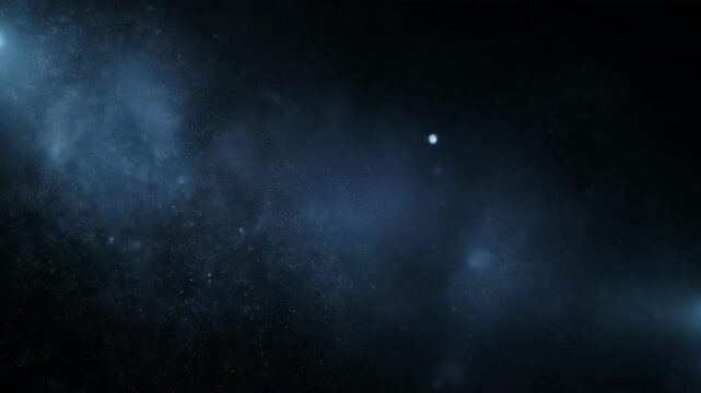 Close-up of floating dust particles or powder against a dark background
