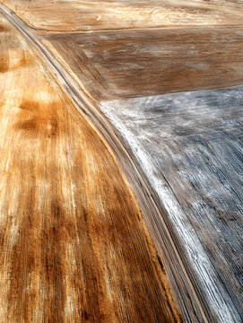 Golden field brown field plowed field dirt road aerial view textured soil harvested field winter residue rural landscape farm land abstract pattern crop stubble arid soil agricultural field earth