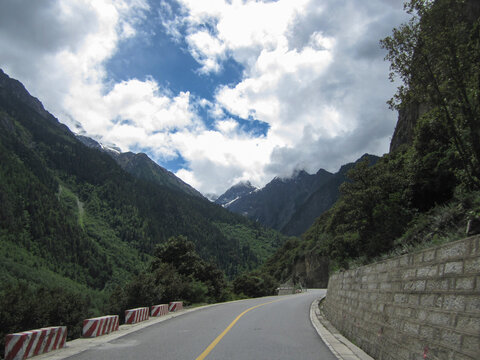 Scenic mountain road with lush green mountains and blue sky
