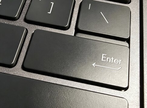 Macro Close Up of Enter Return Key on Modern Black Laptop Keyboard