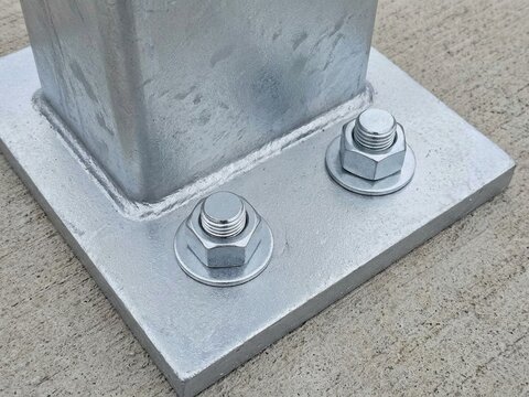 Galvanized Steel Post Base Plate Anchored with Heavy Duty Bolts to Concrete Foundation