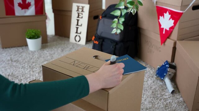 Woman Labeling Moving Box New Life After Moving to Canada