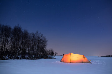 Illuminated tent under a clear sky in winter © Alexander Erdbeer