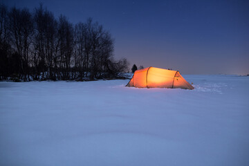 Illuminated tent under a clear sky in winter © Alexander Erdbeer