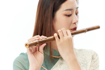 Young woman in traditional Chinese dress playing bamboo flute © LuuNhan