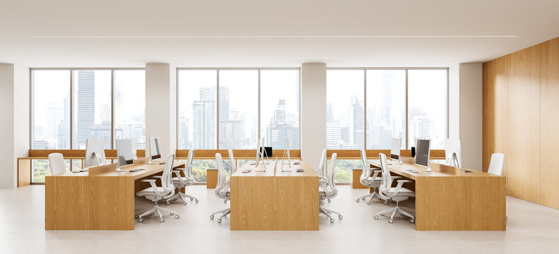 Contemporary open plan office interior design with wood workstations, ergonomic chairs, computers, and panoramic city windows. 3D Rendering
