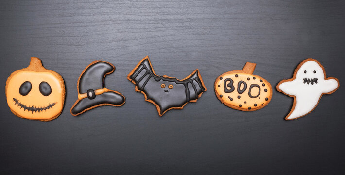 Lots of Halloween gingerbread cookies on dark background. Homemade Halloween gingerbread cookies