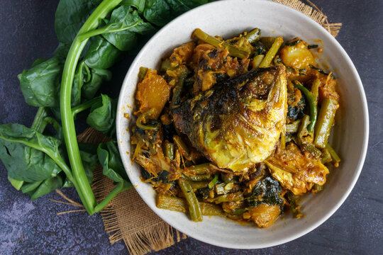 Ilish Macher Matha Diye Pui Shaker Ghonto Traditional Bengali Hilsa Fish Head with Malabar Spinach Curry Served in a Bowl
