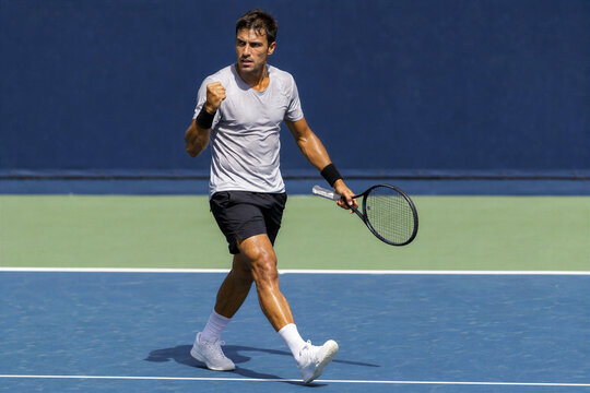 Elite Male Tennis Player Making Powerful Fist Pump on Outdoor Hard Court