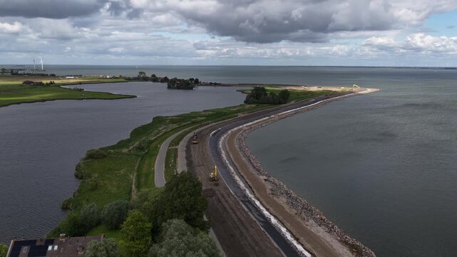 Aerial view of dike reinforcement construction works along dutch coastline