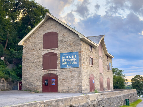 Ottawa, Ontario, Canada. August 21, 2026. Exterior view of historic stone Mus&eacute;e Bytown Museum building near Rideau Canal locks under sky.