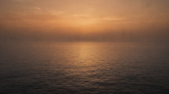 warm amber twilight sky seamlessly blending into a perfectly calm sea with barely visible gentle ripples on the surface