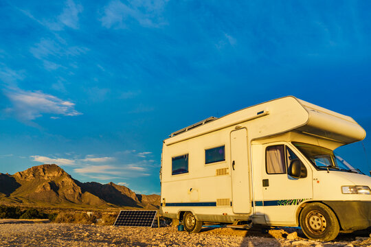 Camper with solar panel on sea coast. Mediterranean region of Mazarron in Murcia Spain.