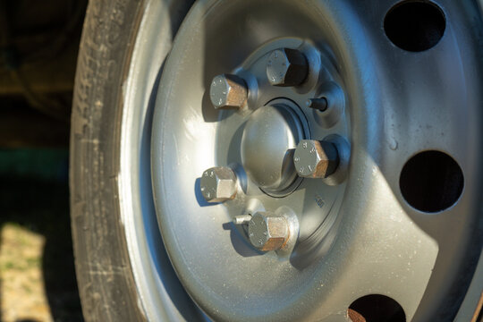 Close view of a metal wheel rim showing bolts and details on a vehicle