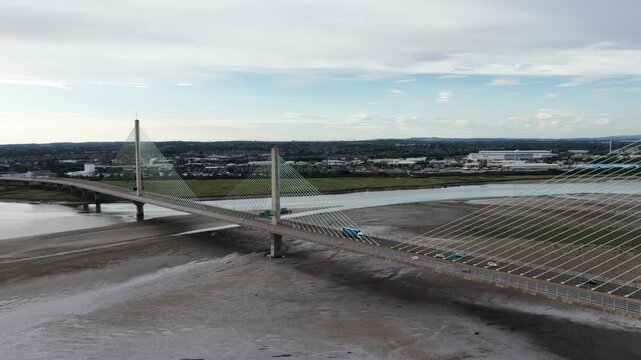 Aerial view of mersey gateway bridge traffic crossing river