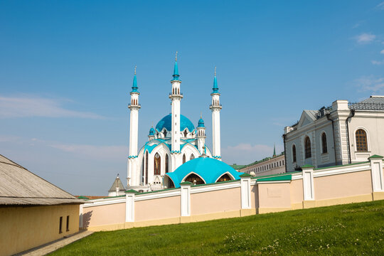 Kul Sharif mosque with blue domes and minarets rising above white kremlin wall, Tatarstan landmark scene