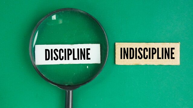 Magnifying glass with the words discipline and Indiscipline. choose a discipline. training that develops self-control, obedience, or order