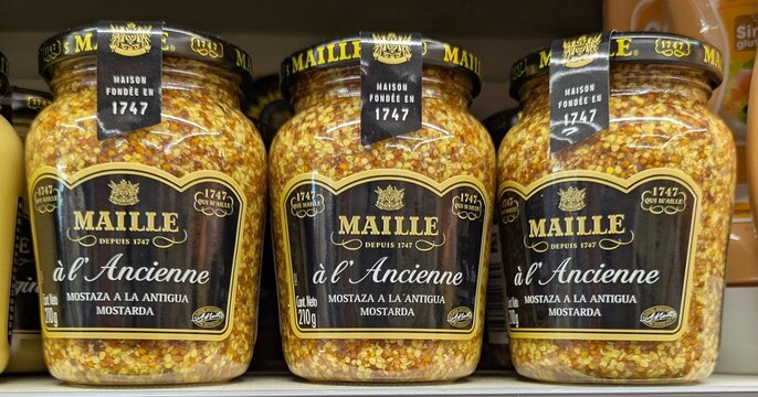 Tarros de cristal con tapa met&aacute;lica de mostaza de Dijon  a la antigua Maille en estanter&iacute;a de supermercado en Madrid, Espa&ntilde;a, 9 de junio de 2026