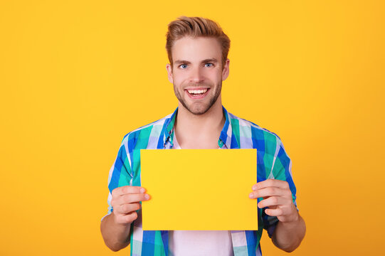 Man with yellow paper. Promotion and presenting. Man announcer promote idea. Man with copy space advertisement. Guy advertising. Announcement. Shopping sale and discount. Presenting product