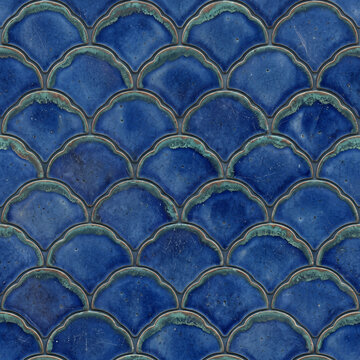 Seamless Glossy deep blue ceramic tiles arranged in a classic fish-scale or scalloped overlapping pattern with darker edges and reflective surfaces.