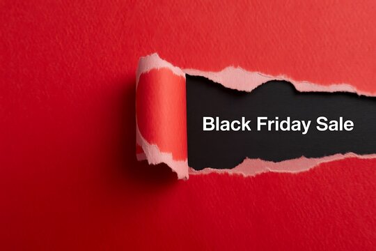 Black friday sale text revealed behind a torn red paper background with a copy space area