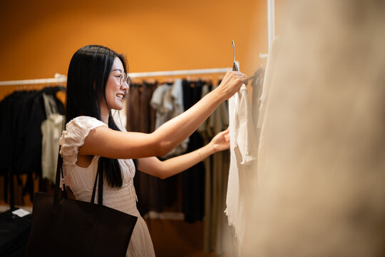 Woman shopping for clothes in retail store