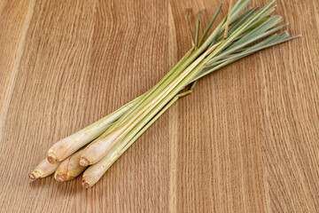 Fresh lemongrass stalks on wooden surface © Andrei Starostin