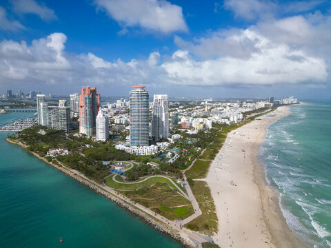 Miami cityscape with luxury skyscrapers and ocean. Panoramic drone view of Miami coastline. Miami Beach from above. Miami skyline from top.