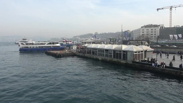 Istanbul, Turkey - February 29, 2024: Ferry terminal pier and waterfront in Eminonu
