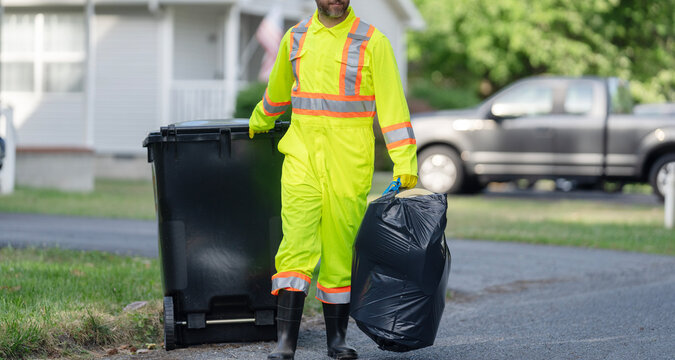 Keeping garbage plastic into bag for trash. Pollution and recycling. Man putting garbage bag in a trash bin, cropped view. Environmental protection. Picking up garbage plastic for cleaning