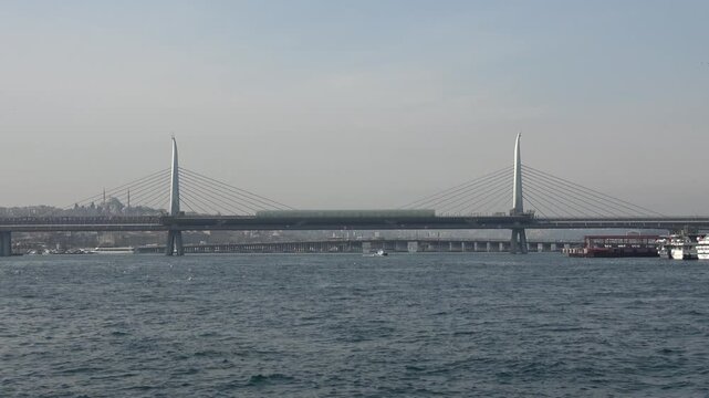 Istanbul, Turkey - February 29, 2024: Golden Horn Metro Bridge view in winter
