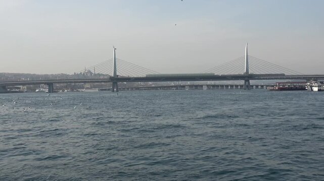 Istanbul, Turkey - February 29, 2024: Zoom in Golden Horn Metro Bridge view in winter
