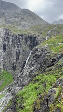 Video of rainy Trollstigen mountain road winding up through deep valley from the viewpoint