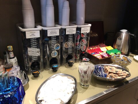 FLORENCE, ITALY - MAY 16, 2017: Coffee supplies and condiments arranged at an airport refreshment area. The photograph documents air travel and airport activity as seen on the stated date.