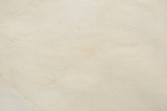 Old vintage paper texture background with aged stains and antique yellowed parchment effect
