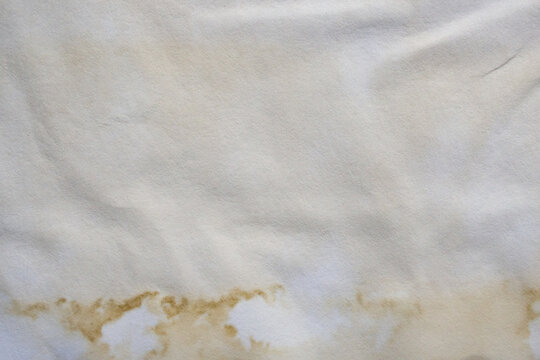 Old vintage paper texture background with aged stains and antique yellowed parchment effect