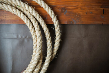 Coiled rope on rustic wood and leather © wdnld