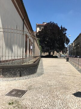 Pedestrian walkway beside the Santa Maria delle Grazie complex in Santa Maria delle Grazie, Milan, Italy. The image presents the visible surroundings and travel setting in a clear, factual travel phot