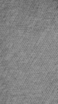 Overlay grey texture. Seamlessly looping vertical stop motion animation of rapidly changing grey cloth texture.