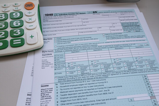 US Individual Income Tax Return Form 1040 with Calculator and Pen for Annual Tax Filing Concept